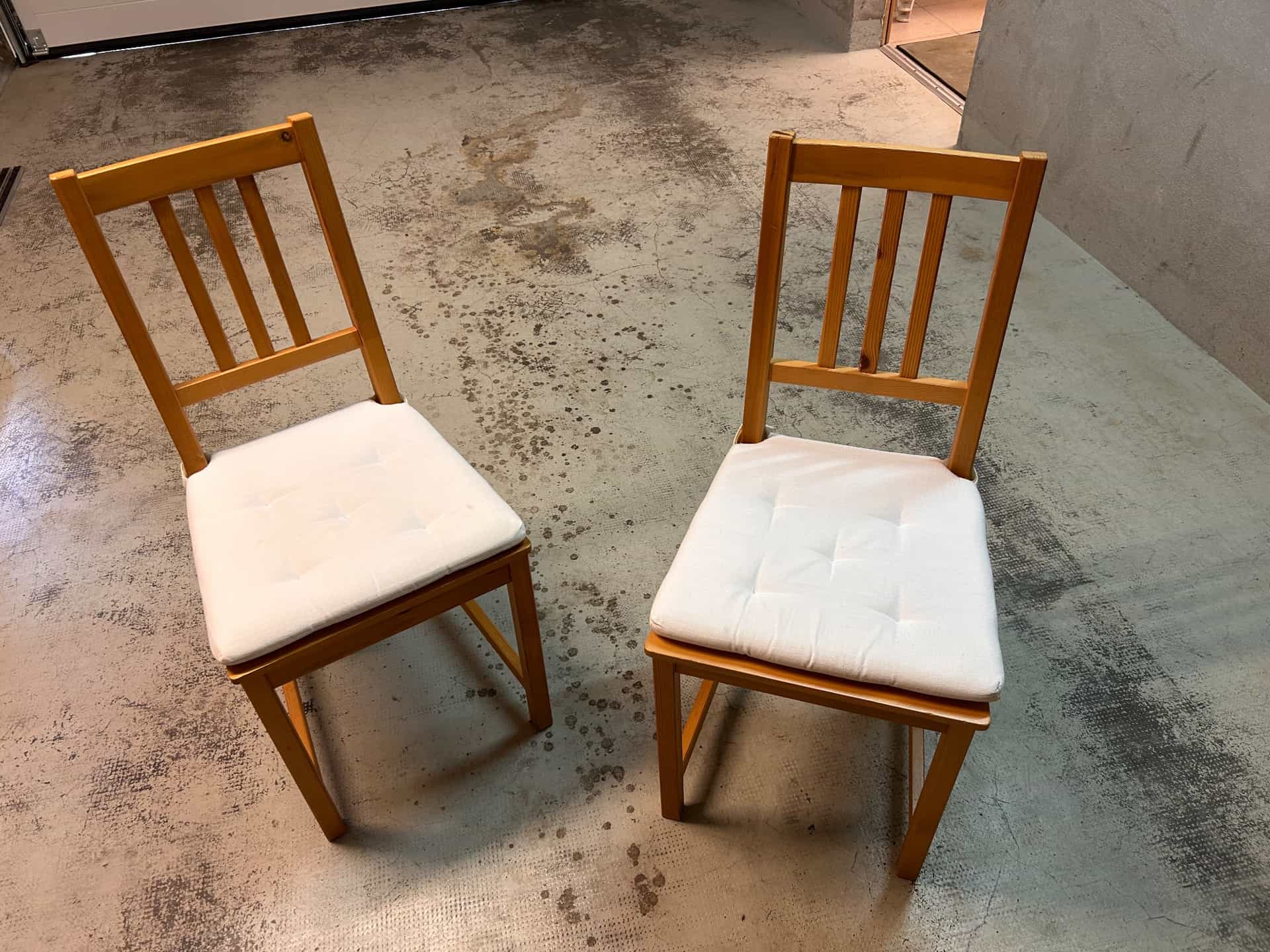 Wooden dining chairs with white cushions