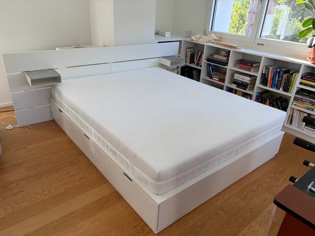 Bed frame with headboard, storage drawers below and nightstand, white