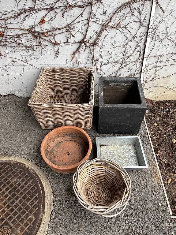 Diverse Töpfe aus Ton, Stein und Korbgeflecht